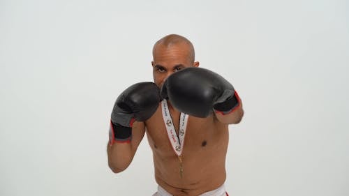 A Male Boxer Wearing a Gold Medal
