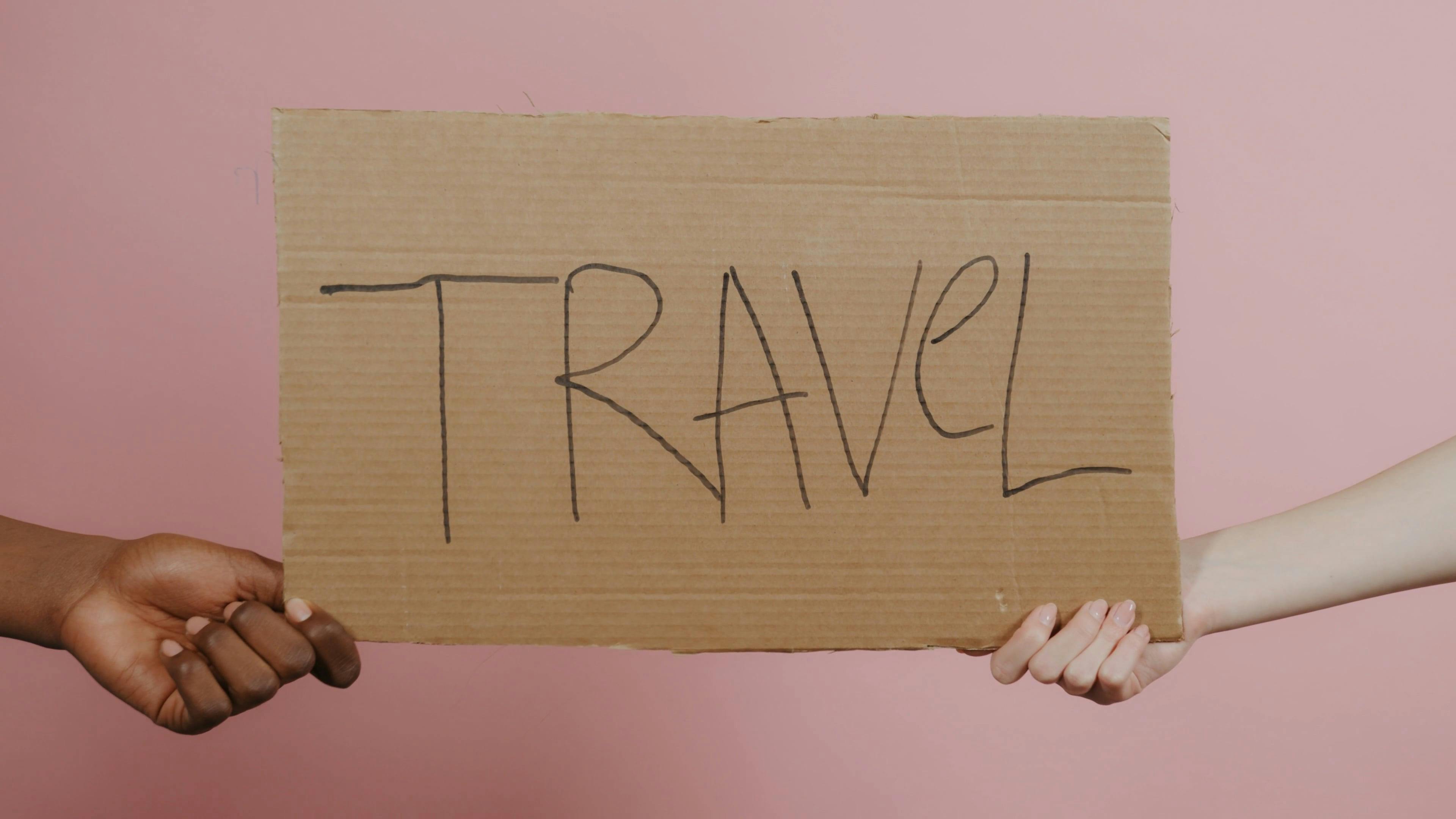 people holding travel placard 7009533