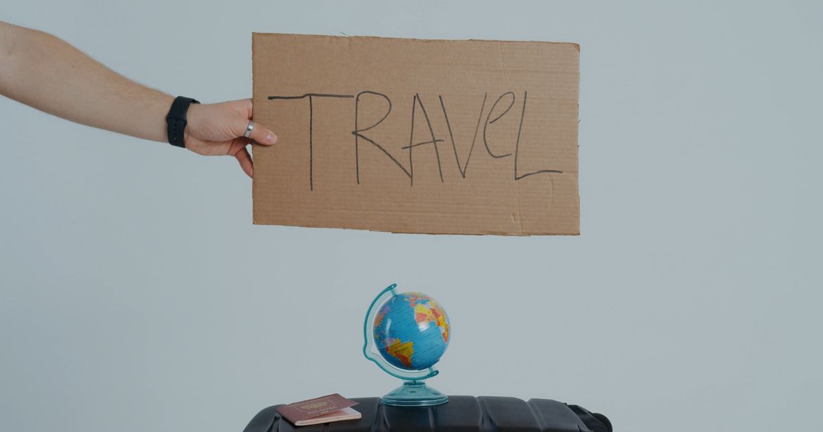 person holding a cardboard with written message 7010564