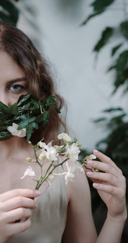 Woman Holding Bunch Of Flower While Wears Face Mask