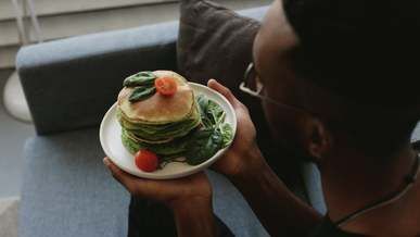 a man holding a vegan pancakes