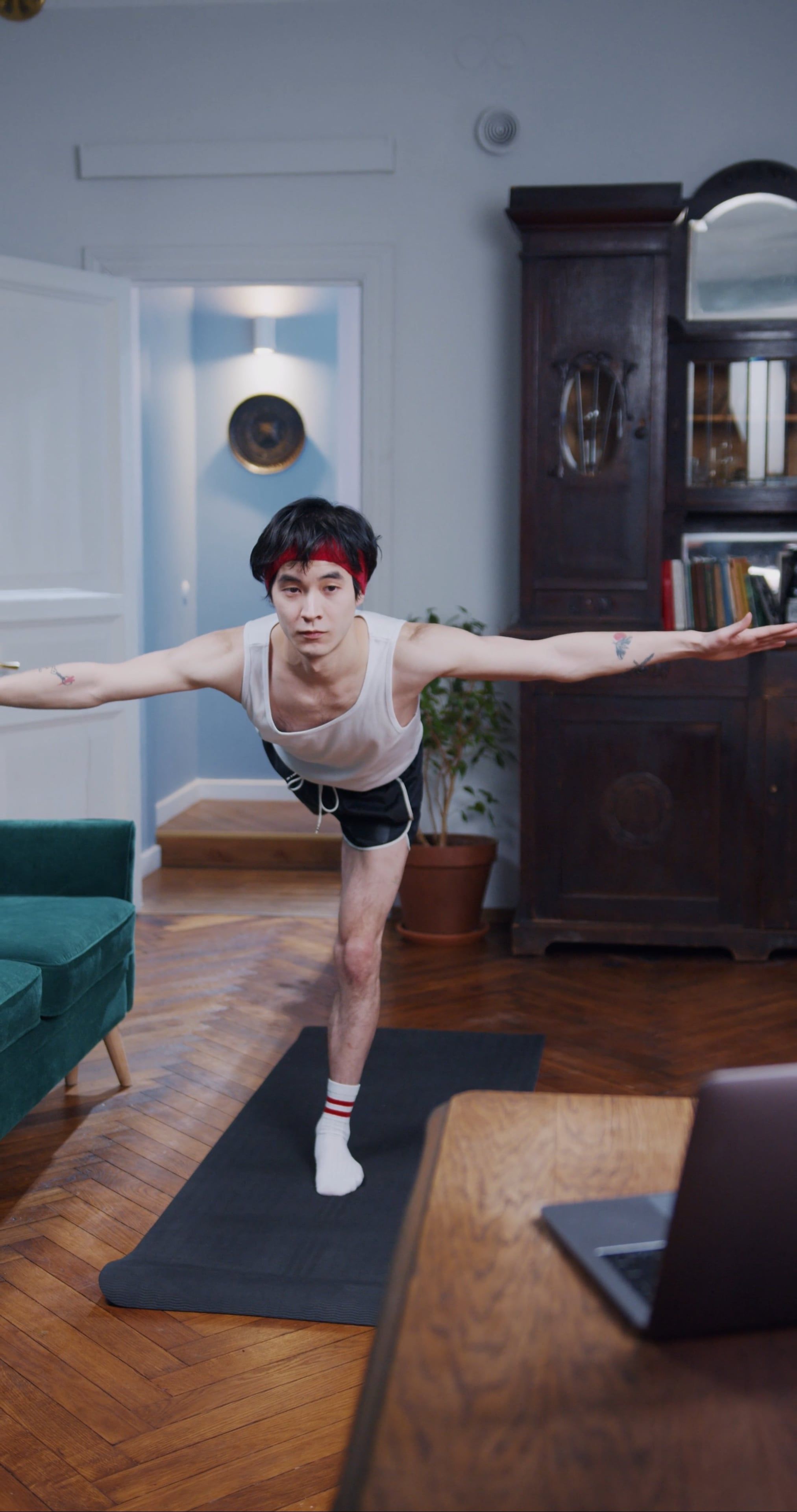 A Man Doing Yoga Pose In Front Of A Laptop Free Stock Video