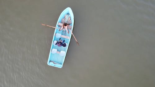 Drone Footage of People Riding a Wooden Boat