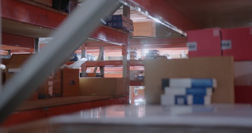Woman Model while Standing in an Aisle in Between the Racks Free Stock ...