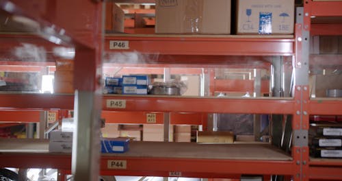 Woman Model while Standing in an Aisle in Between the Racks Free Stock ...