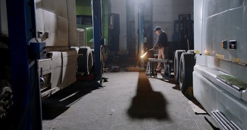 A Mechanic Using a Blowtorch