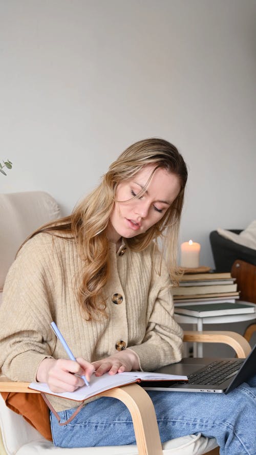 A Woman Writing on the Notebook