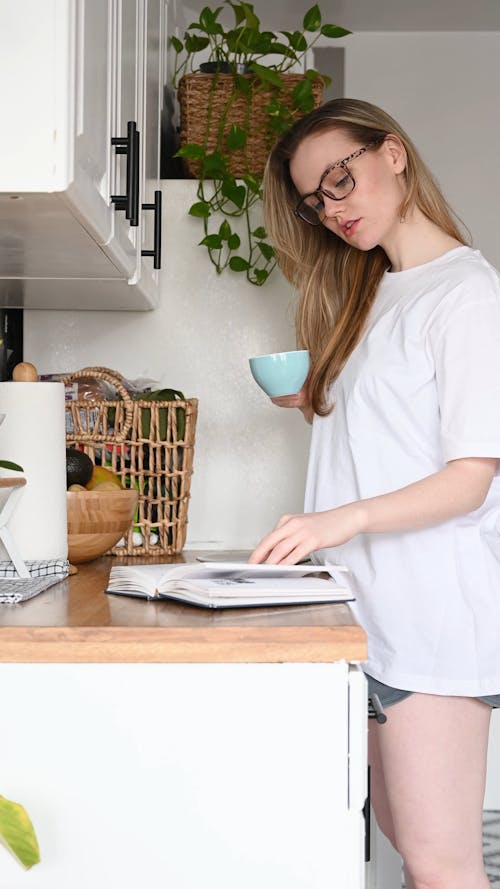 Woman Reading a Book while Drinking Coffee