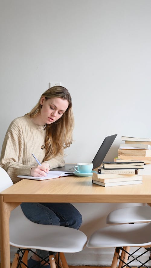 Woman Writing on Notebook