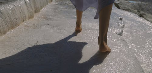 Woman Walking on wet Rock