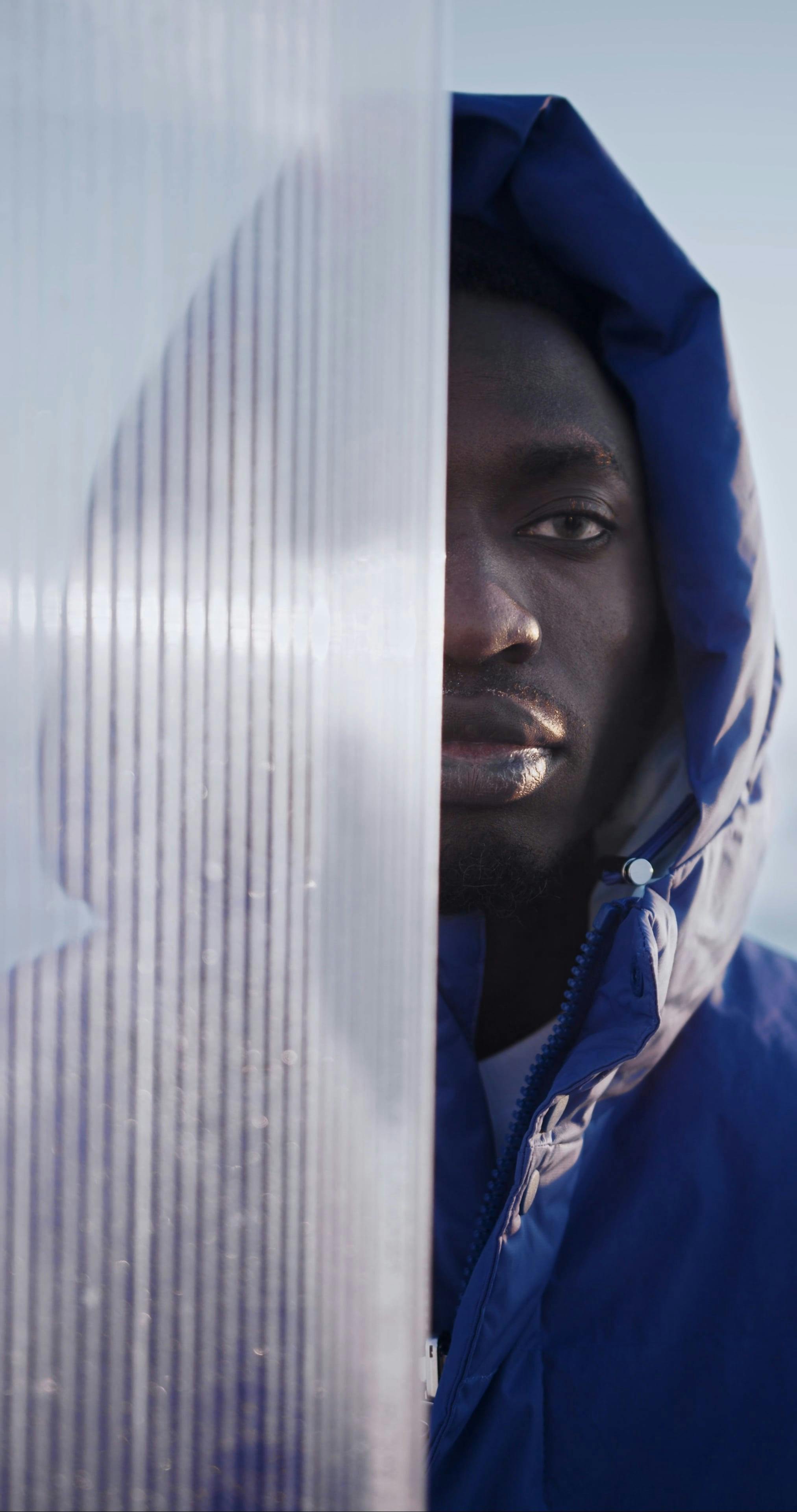 A Person in a Blue Puffer Jacket Posing · Free Stock Video