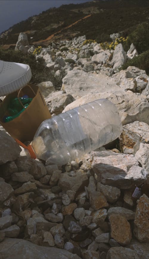 A Person Stepping on a Plastic Bottle