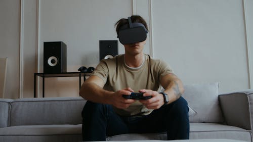Young Man Playing a Game on a Virtual Reality Headset