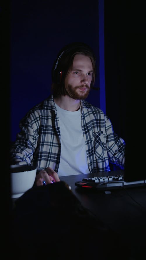 A Man Celebrating while in front of the Computer