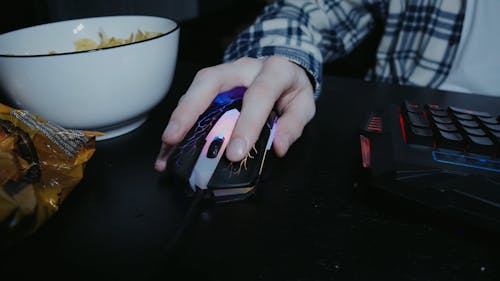 A Person Using a Mouse for Gaming