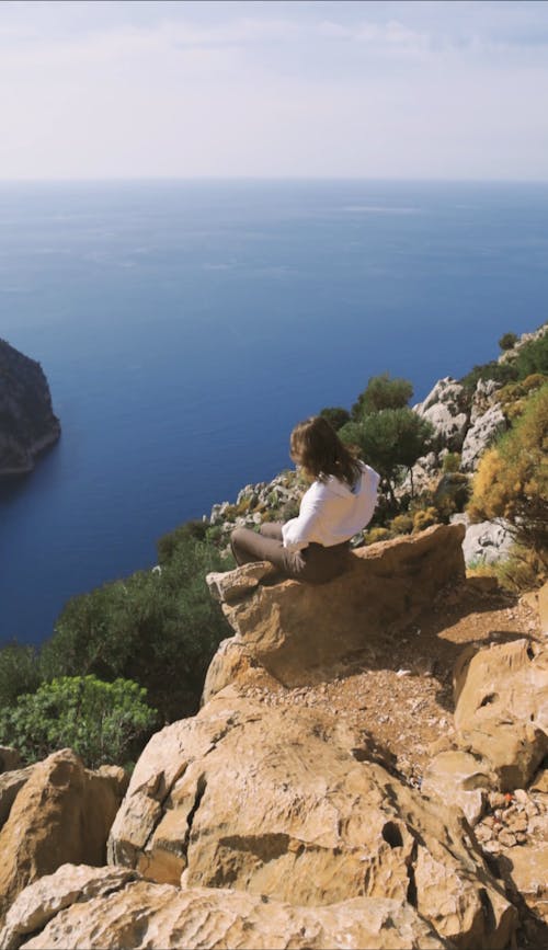 A Woman Sitting on a Rock