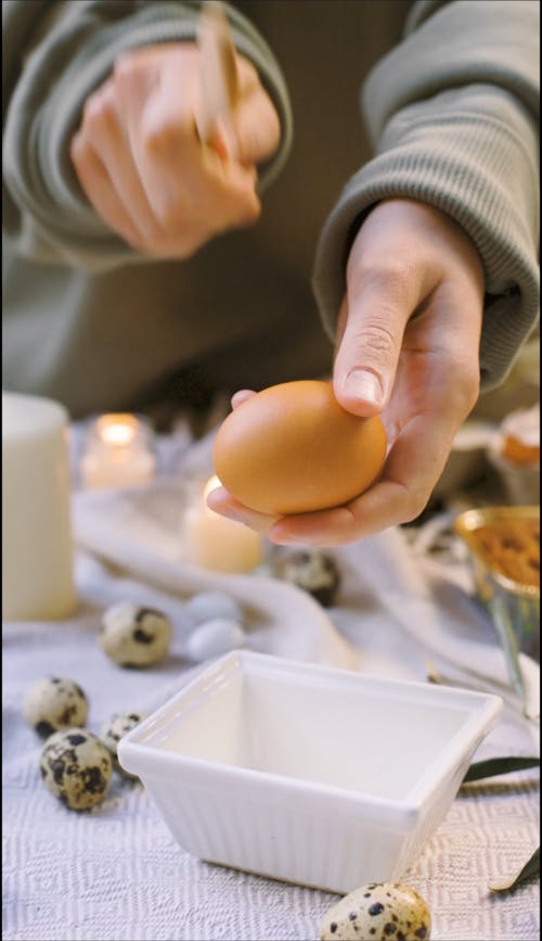 A Person Cracking an Egg