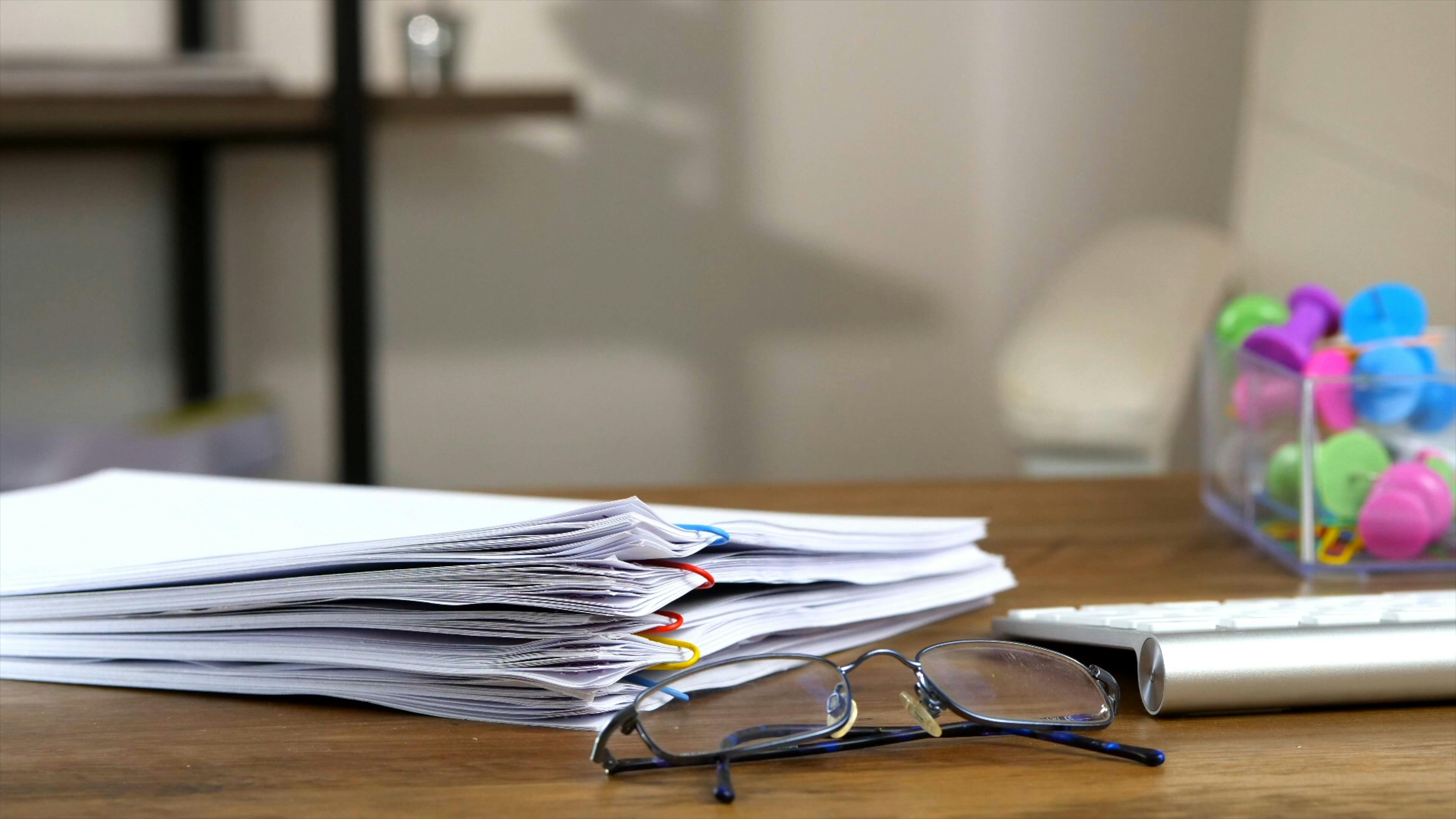 Stack of Paperwork on the Desk · Free Stock Video