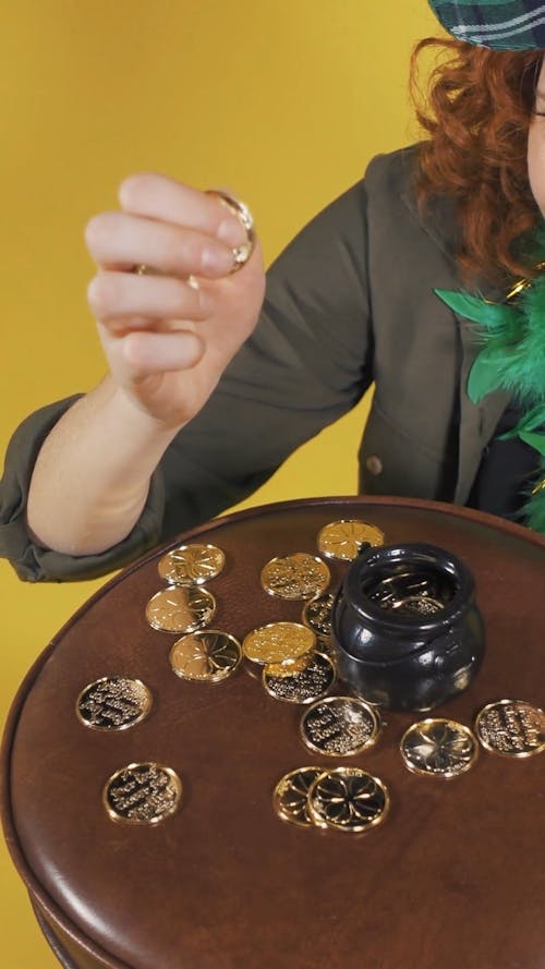 Video of a Woman Playing with Golden Coins