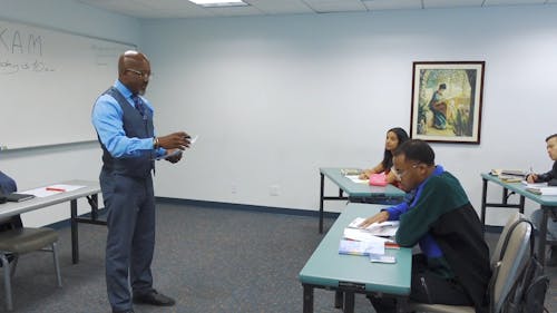 Teacher Giving Test Results to His Students