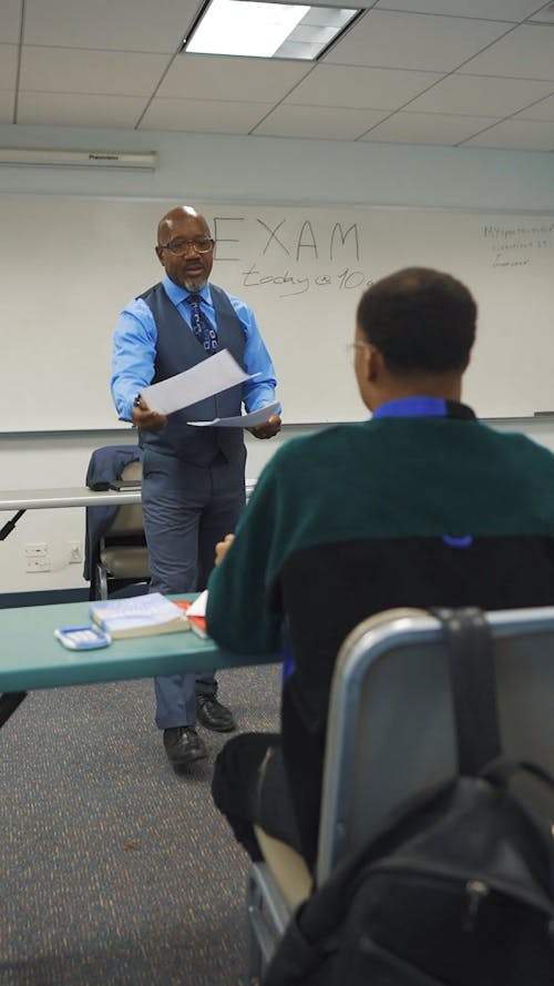 Teacher Giving Test Results to His Students