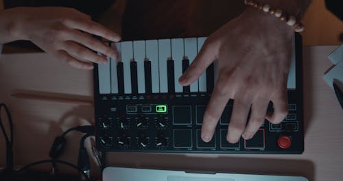 A Person Playing Keyboard Synthesizer