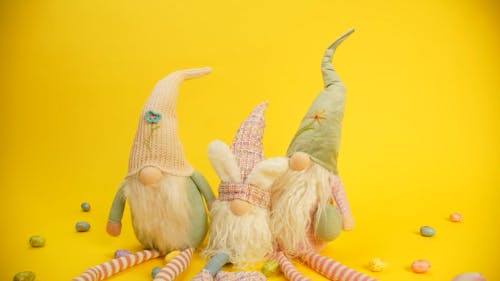 Stuffed Toys and Chocolate Eggs with Yellow Background