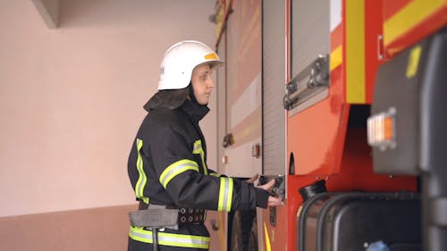 A Fireman Preparing the Fire Truck