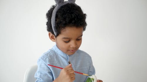 Boy Painting the White Egg