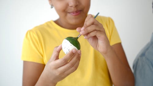 A Child Painting an Egg