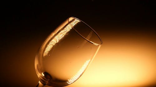 Pouring of Red wine on a Glass