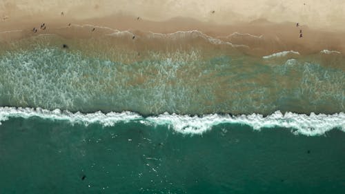 An Aerial Footage of  the Crashing Waves to the Shore