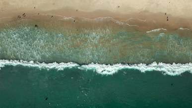 an aerial footage of the crashing waves to the shore