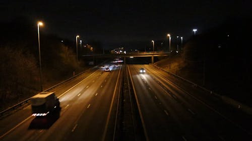 Vehicles Passing by the Expressway at Night