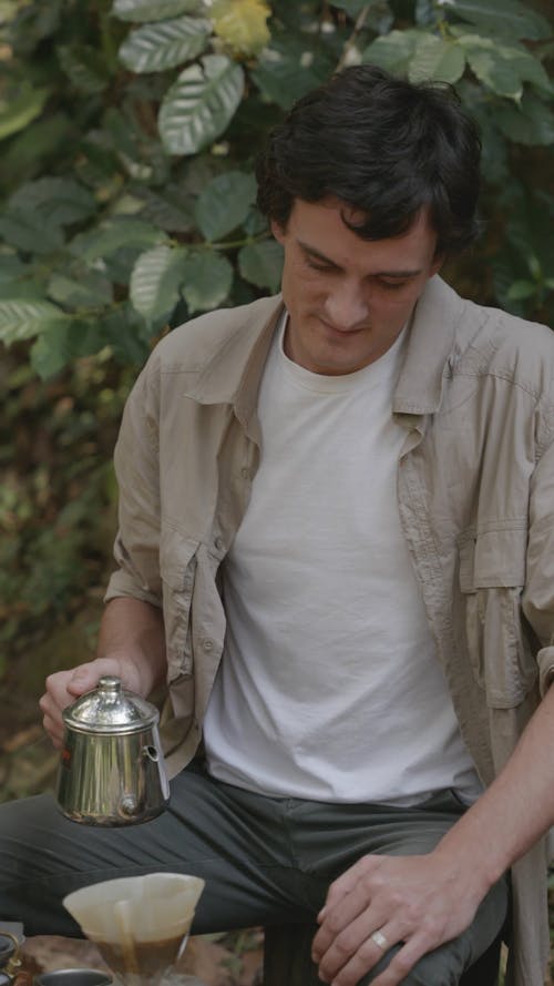 A Man Brewing Coffee Outdoors