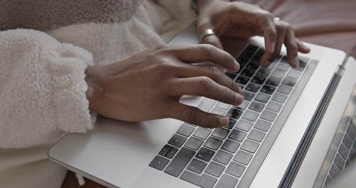 Man Typing on his Laptop
