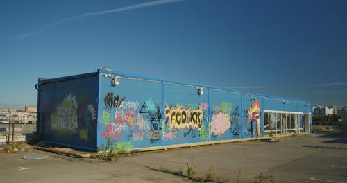 Person Making Graffiti Art on a Cargo Container