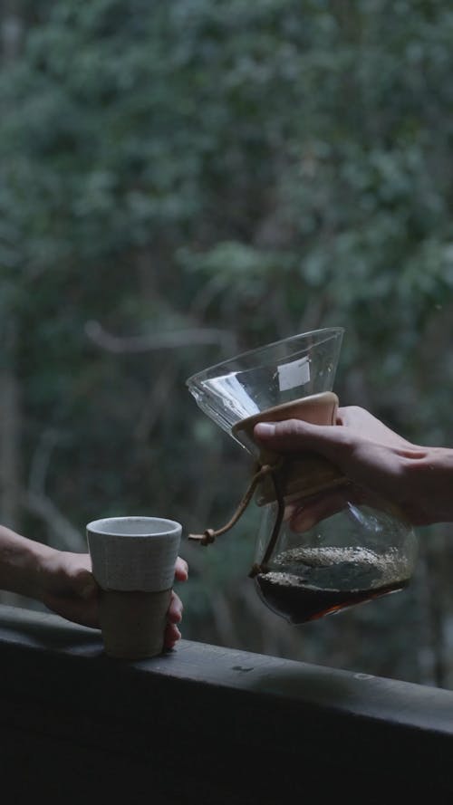 Pouring Black Coffee into a Cup