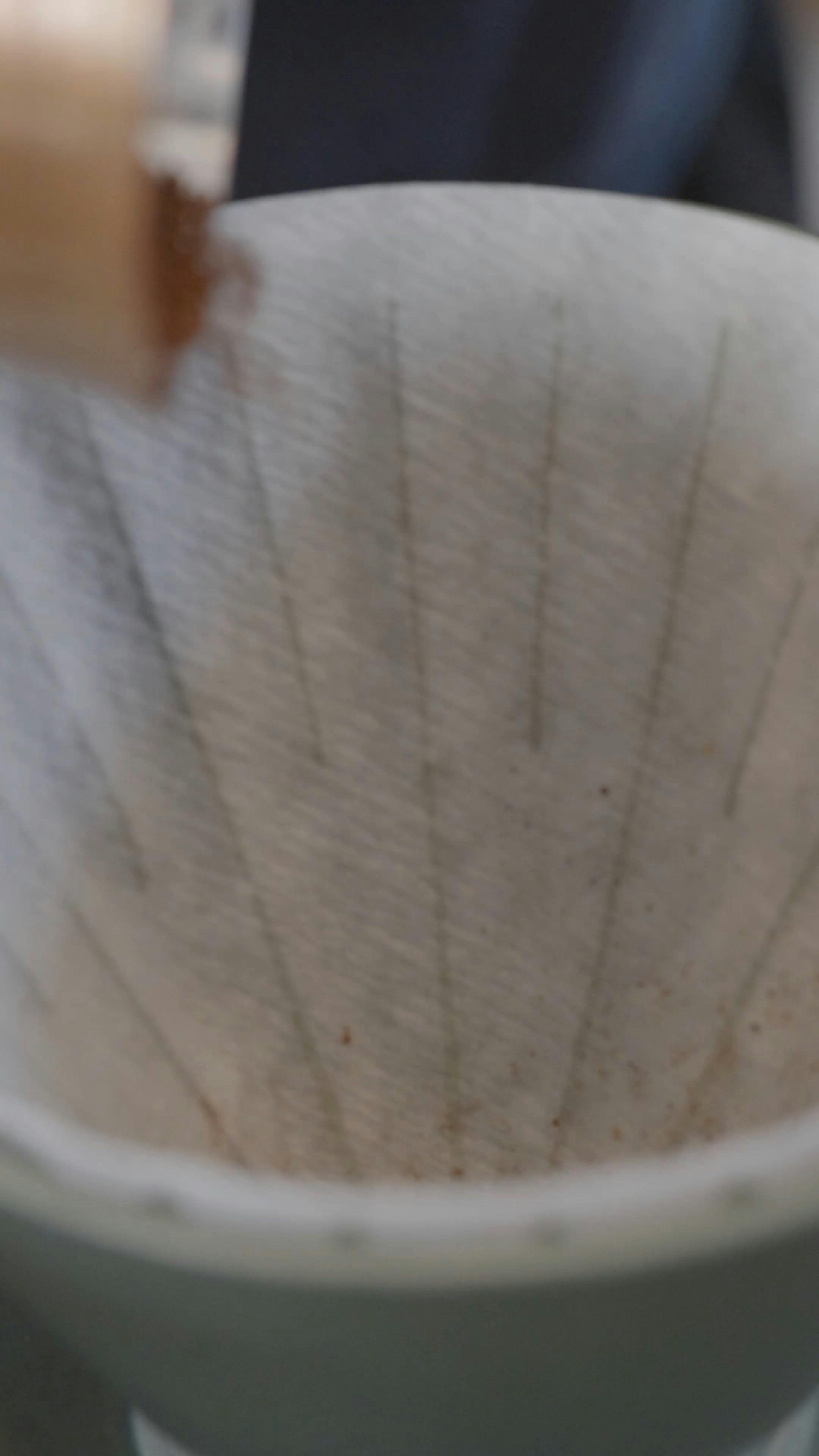 Putting Coffee Powder into a Paper Filter · Free Stock Video
