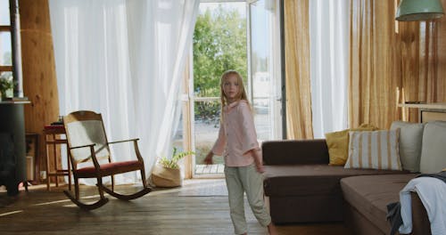 A Girl Spinning and Sitting Down on the Couch