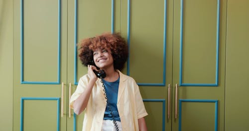 Woman Having Fun while Talking on the Phone