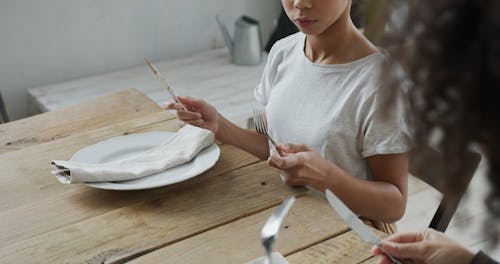 Person Teaching a Girl about Table Etiquette