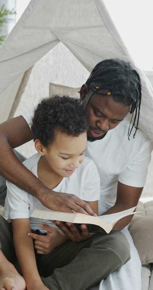 Dad Reading a Book for His Child