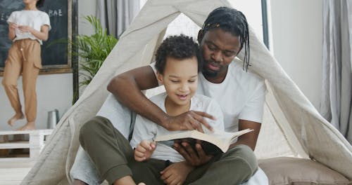 A Father Reading a Book With His Son