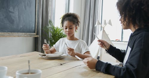 Mother Teaching Her Daughter about Table Etiquette