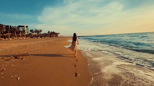 Woman Walking on the Beachside