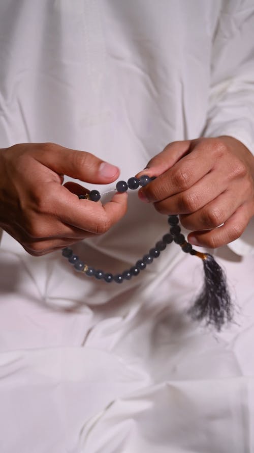 Man Praying with Prayer Beads