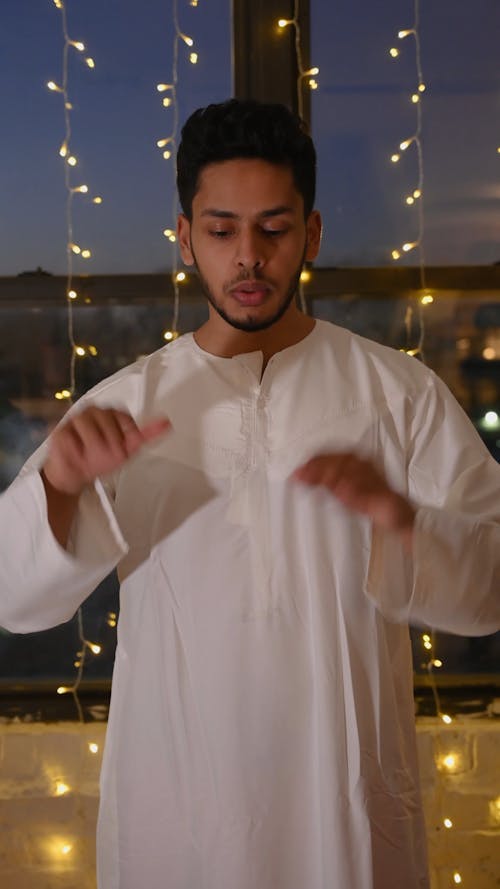 A Man Praying Wearing Thobe