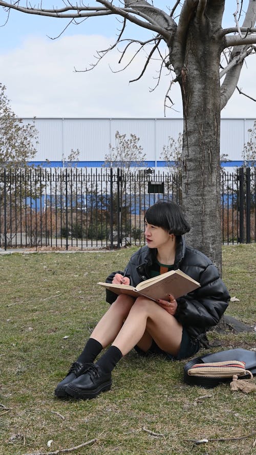 Video of a Woman Sitting Under the Tree