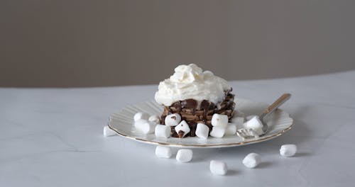 Chocolate Drink with Marshmallows and Pancakes Covered with Whipped Cream